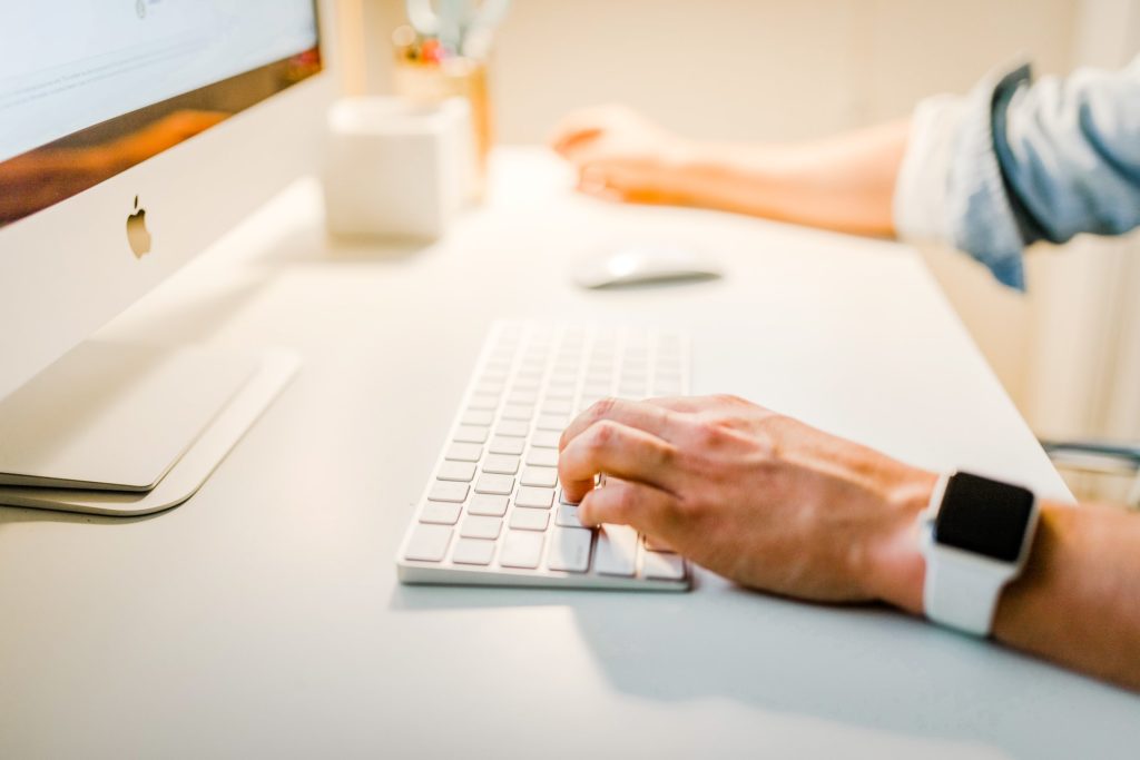 a man working on a white computer