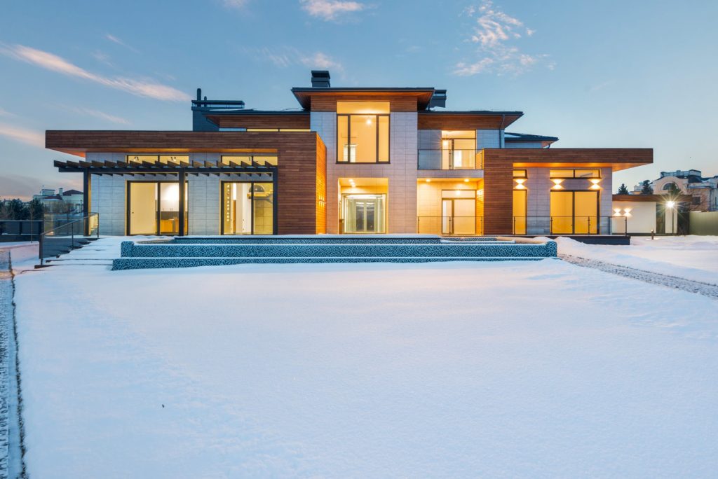 a large house with a pool in the snow