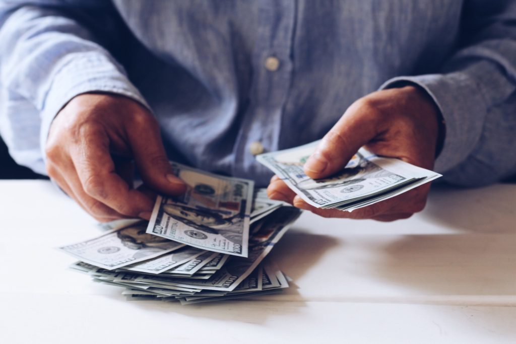 a man holding a stack of money